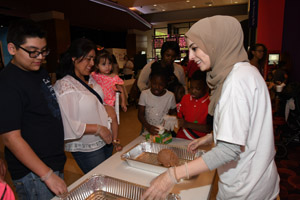 a woman explaining about the human brain to a young man in a black shirt