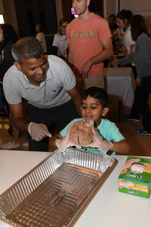 a small child holding a human brain