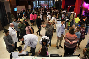 a long shot of the exhibition hall that shows multiple people and exhibits