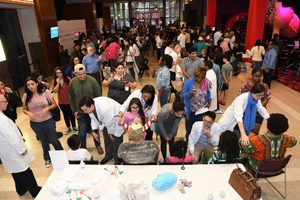 A long shot of the entire exhibit hall showing a sizable crowd