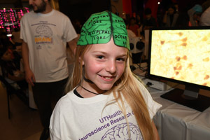 Blonde girl modeling her new green brain hat