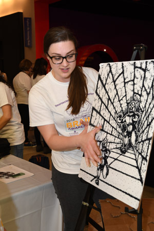 a woman explaining perpective and how the brain sees an image at differnt points along perspective drawing