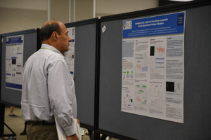 A man with a clipboard judging a poster