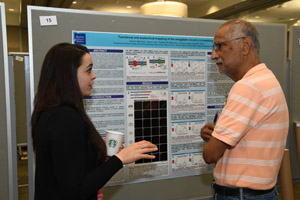 A male and a female discussing the presentation board in front of them