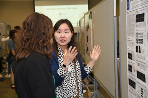 Two women discussing a presentation poster