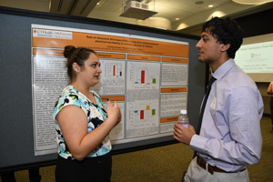 A man and a woman discussing a poster