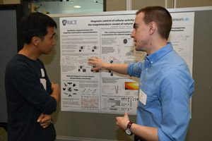Two young men discussing a presenation poster
