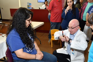 a man explaining a perception experiment to a young girl