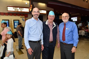 Thre doctors observing Brain Night, one wearing a blue brain hat