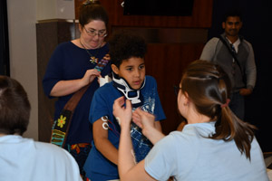 a perception experiment being performed on a male tween by two adult females