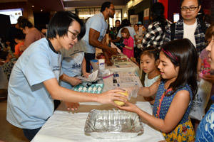 A girl experimenting with an egg and a grapefruit