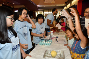 A young girl completing her grapefruit and egg experiment